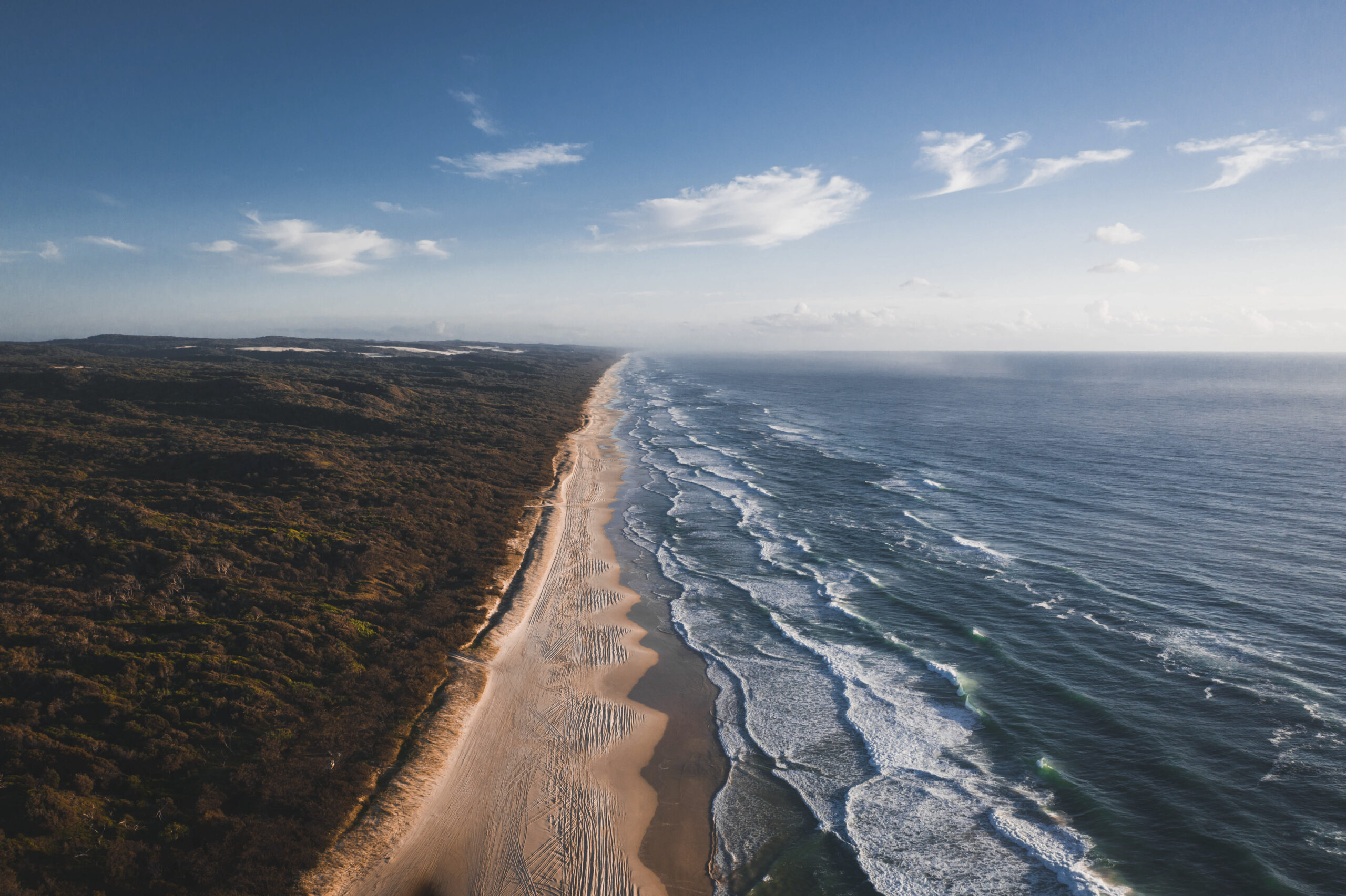 Drone view of a coastline under a blue sky